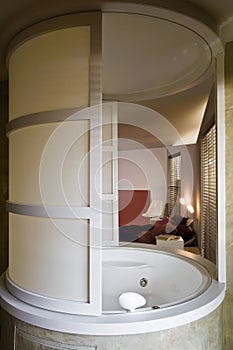 Round hydromassage bath in the bedroom