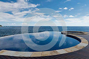 Round infinity pool merge indian ocean view photo