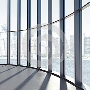 Round interior with large windows and sunlight.