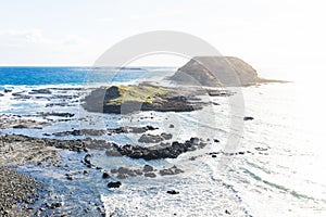 Round island surrounded by water at the Nobbies at Phillip Island, Victoria, Australia