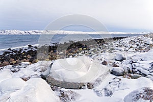 Round large stones on the shore of the Arctic Ocean. Dragon eggs beach. Teriberka Russia, Kola peninsula. natural attractions of