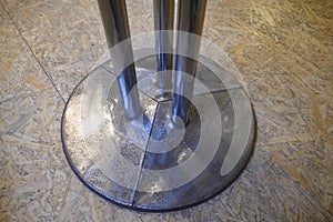 Round leg of a table on a wooden floor photo