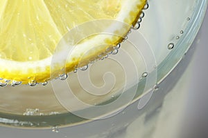 Round lemon slice in slaked soda water