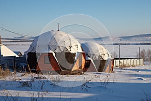 Round lodges for rest on the shore of the Large Lake, in the village.