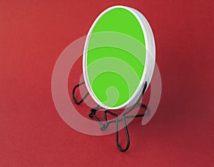 Round make up mirror on a red background. screen for inserting any reflection and image. copy space