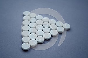 Round medicinal pills in shape of large triangle