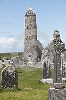 Round medieval tower still standing at Clonmacnoise photo