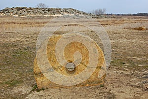 Round megalithic stone in the steppe.