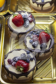 Round mini cake, coffee and vanilla souffle with strawberries, blackberries, raspberries, blueberries