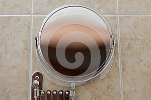 Round mirror in the bathroom mounted on the wall