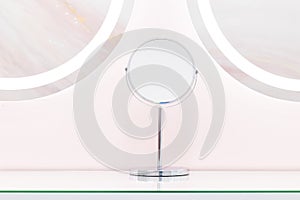 Round mirrors with illuminated reflections, modern design pastel blue and pink stylized in a beauty studio salon