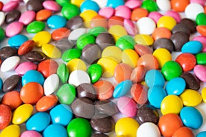 Round, multi-colored, chocolates. A pile of multicolored candies
