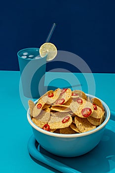 Round nachos corn tortilla chips with red chili slices
