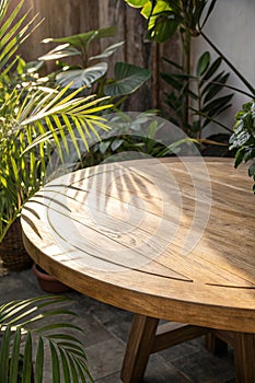 Round Oak Table with Sunlight and Tropical Leaves