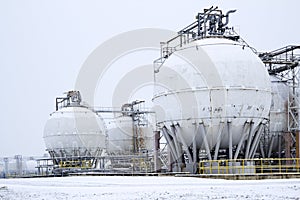 Round oil tanks under snow cover