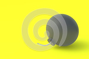 Round old bomb with fuze on yellow background. Copy space
