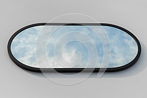 A round or oval mirror with a reflection of the blue sky and white clouds. Close-up. Isolated on a white background