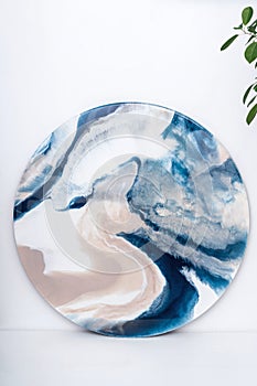 Round painting in technik fluid art, resin art. Artistic concept.