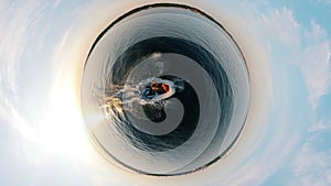 Round panorama of two men sailing in an inflatable boat