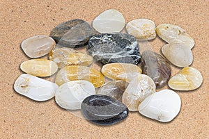 Round pebble stones on beach sand. Top view