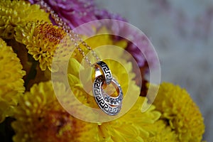 Round pendant on yellow marigolds photo