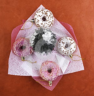 round pink and white donuts with chocolate sprinkles and christmas tree