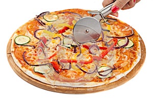 Round pizza cutter in a female hand