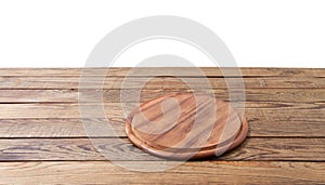 Round pizza food cutting board on brown wooden table isolated on white background. Wood tray plate and table top view. Empty copy