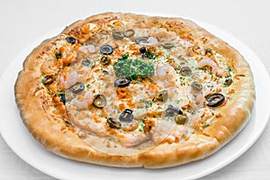 Round pizza on a white plate