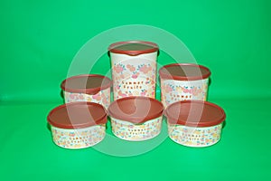 Round Plastic Jar with Brown Lid and Fruit Illustration
