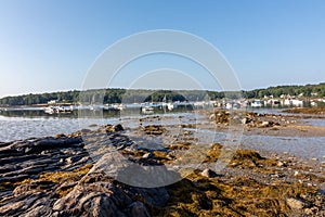 Round Pond harbor, Maine, USA, on an early summer morning with blue skies and dotted clouds