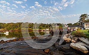 Round Pond harbor, Maine, USA, on an early summer morning with blue skies and dotted clouds