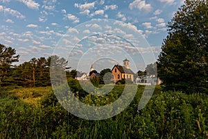 Round Pond harbor, Maine, USA on an early summer morning with blue skies and dotted clouds