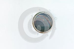 Round porthole on the ship white wall