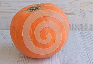 Round pumpkin on a wooden surface