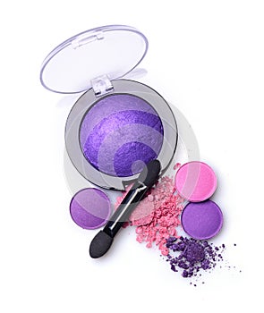 Round purple crashed eyeshadow for makeup as sample of cosmetics product with applicator