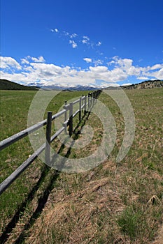 Round rail fence under blue sky in the Bighorn Mountain range in the Rocky Mountains near Buffalo Wyoming US photo