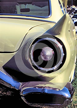 Round rear taillight on a yellow 1950s classic car