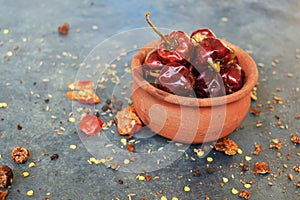 Round red chillies on the small clay pot.