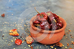 Round red chillies on the small clay pot.