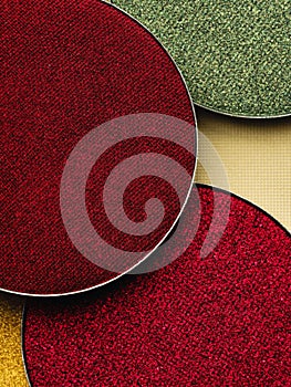 Round red and green eyeshadow palette background.
