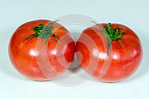 Ripe red raspberry tomatoes on white background