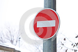 Round red stop sign on a metal pole