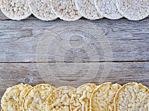 Round rice cakes and corn cakes on wooden table.