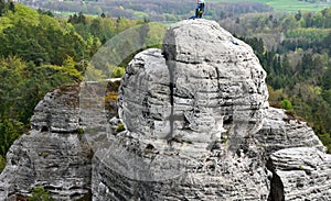 Round rock formations attract climbers. sandstone rock towers polished by wind erosion. deciduous, mixed forest with beeches in ea
