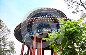 Round roof of Pavilion in Jingshan Park Beijing. Traditional Chinese-style pavilion on a hill against a blue sky.