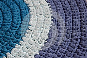 Round rug made of handmade knitted yarn.