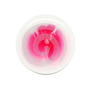 Round sample of serum oil texture with red ingredient and bubbles isolated on white background