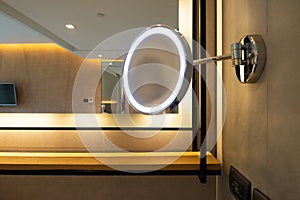 Round shape make-up mirror with lights in bathroom at the hotel