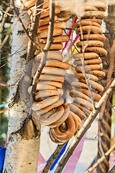 Round-shaped cracknel on rope hanging on burch photo